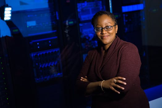 Confident woman in data center, showcasing tech expertise.