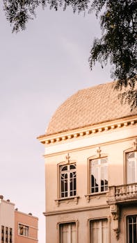 Elegant facade of a historic building in Curitiba, Brazil, captured during sunset.