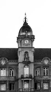 Vintage black and white photo of a historic clock tower with ornate architectural details.
